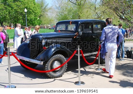MOSCOW, RUSSIA - MAY 09: Black vintage car. Holiday decoration on the Gorky park. Victory Day celebration on May 09, 2013 in Moscow.