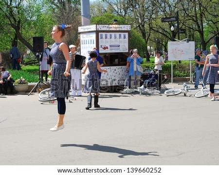 MOSCOW, RUSSIA - MAY 09: Young actress jumps, she performs in the Gorky park. Victory Day celebration on May 09, 2013 in Moscow.