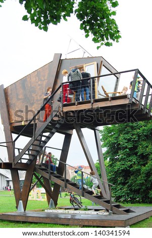 MOSCOW, RUSSIA - MAY 25: A small wooden house in the park. Outdoors exposition of MICRODOM - XV architectural festival GORODA. Location: Park of arts Ã¢Â?Â?MuzeonÃ¢Â?Â?, Moscow. Taken on May 25, 2013 in Moscow.