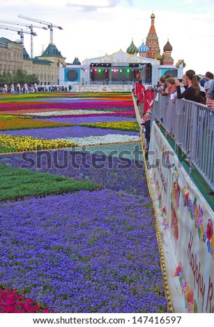 MOSCOW - JULY 23: 4000 square meters of different flowers put on the Red Square on the occasion of 120th anniversary of GUM - State Department store opening. Taken on July 23, 2013 in Moscow.