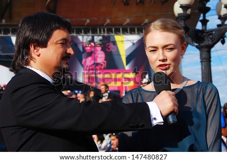 MOSCOW - JUNE 20: Actress Oksana Akinshina gives interview to tv host Ildar Zhindarev at XXXV Moscow International Film Festival red carpet opening ceremony. Taken on June 20, 2013 in Moscow, Russia.