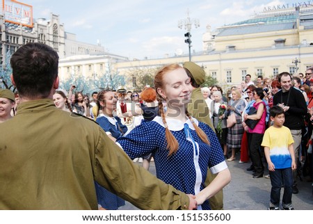 MOSCOW, RUSSIA - MAY 09: Young actors dressed as army soldiers perform on the Theater Square, by the Bolshoi Theater. Victory Day celebration on May 09, 2013 in Moscow.