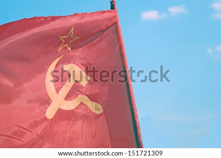 Red flag of the Soviet Union. Blue sky background.