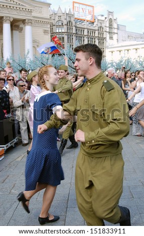 MOSCOW, RUSSIA - MAY 09: Young actors dressed as army soldiers perform on the Theater Square, by the Bolshoi Theater. Victory Day celebration on May 09, 2013 in Moscow.