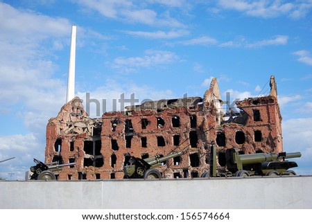 Stalingrad battle war memorial in Volgograd, Russia. A destroyed house and weapons, blue sky with clouds background.