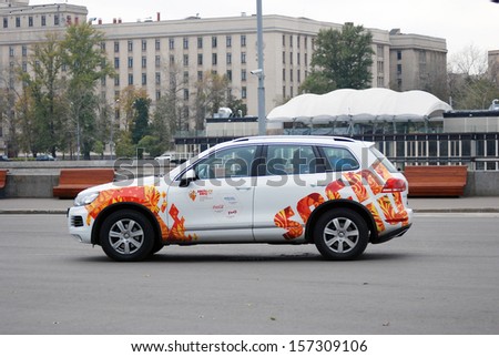 MOSCOW - OCTOBER 07: A sport car decorated by Sochi Olympic games symbols drives in the Gorki park in Moscow on the occasion of the relay of the Olympic Flame on October 07, 2013 in Moscow.