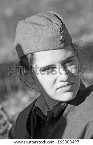 MOSCOW REGION - OCTOBER 13: Portrait of a lady reenactor dressed as WW II soldier on October 13, 2013 in Borodino, Moscow Region, Russia. She\'s reenacting the Moscow Battle held in 1941.