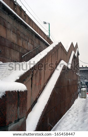MOSCOW, RUSSIA - MARCH 15: View of the Big Stone Bridge covered by the snow and workers cleaning the snow. Moscow city center, popular touristic place. Taken on March 15, 2013 in Moscow, Russia.