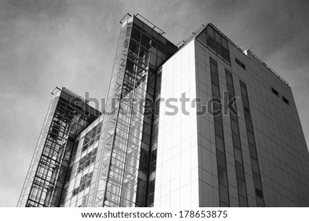 SAMARA, RUSSIA - SEPTEMBER 14, 2013: View of a modern building in Samara city center (Russia), an example of modern architecture in Russian town. Black and white photo. Low angle view.