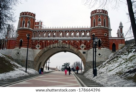 MOSCOW - FEBRUARY 22, 2014: Architecture of Tsaritsyno park in Moscow, Russia, in winter. People walk towards the old bridge.  A popular touristic landmark in Moscow.