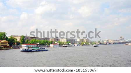 MOSCOW - MAY 11, 2012: View of the the Moscow river embankment, a popular place for walking in Moscow city center. Cruise ships sail on the river. Blue sky with clouds background.