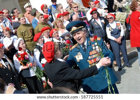 MOSCOW, RUSSIA - MAY 09, 2013: War veterans sing war songs on the Theater Square; by the Bolshoi Theater, traditional place for veterans' meeting.
