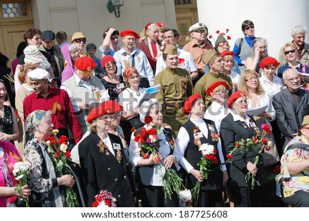 MOSCOW, RUSSIA - MAY 09, 2013: War veterans sing war songs on the Theater Square; by the Bolshoi Theater, traditional place for veterans' meeting.