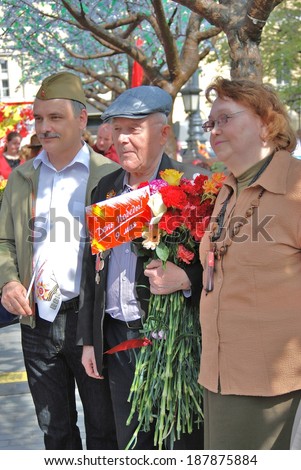 MOSCOW, RUSSIA - MAY 09, 2013: A war veteran holds flowers. Victory Day celebration in Moscow.