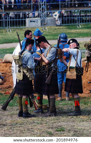 MOSCOW - JUNE 08, 2014: Men in Scottish kilts. First World War battle historical reenactment. Times and Ages International Historical Festival in Kolomenskoye park, Moscow.