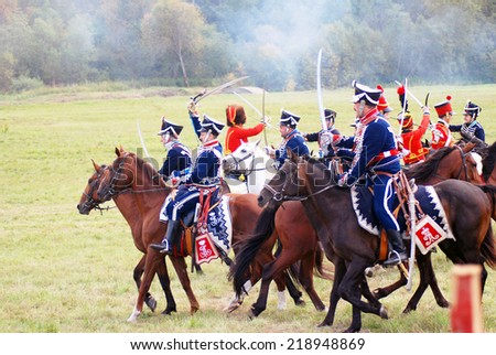 MOSCOW - SEPTEMBER 07, 2014: Reenactors dressed as Napoleonic war soldiers ride horses at Borodino battle historical reenactment.