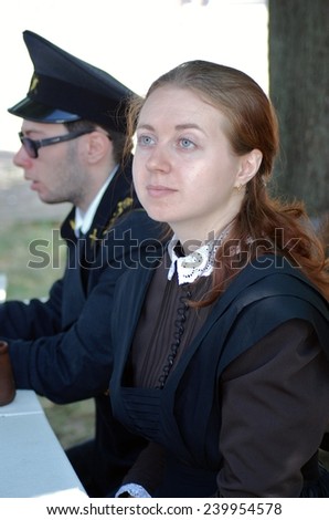 MOSCOW - JUNE 08, 2014: Man and woman in vintage students clothes sit at table. Times and Ages International Historical Festival in Kolomenskoye park, Moscow.