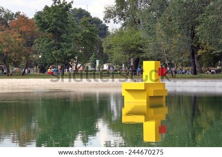 MOSCOW - SEPTEMBER 06, 2014: Yellow bird sculpture floats on the pond. Gorky park i Moscow, popular touristic landmark.