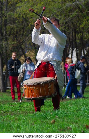 MOSCOW - MAY 02, 2015: Musician dressed in vintage clothes plays in Kolomenskoye park in Moscow.