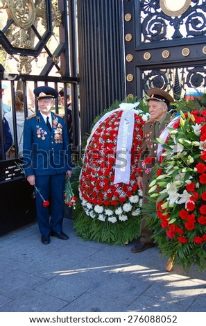 MOSCOW -  MAY 06, 2015: War veterans pose for photos in Alexander\'s garden in Moscow. 70 years anniversary of victory in Second World War celebration in Moscow.