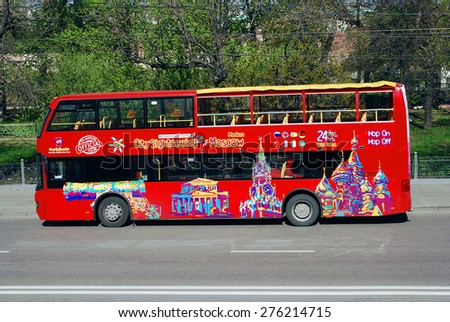MOSCOW - MAY 06, 2015: Touristic bus red double-decker in Moscow city center. Green trees background. Bus tours is a popular entertainment for tourists in Moscow.
