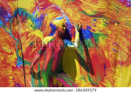 SAINT-PETERSBURG, RUSSIA - JUNE 10, 2015: A woman (street actress) painted by colorful paints poses for photos on Dvortsovaya Square in Saint-Petersburg, Russia.