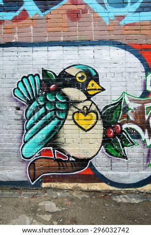 MOSCOW - JULY 12, 2015: A bird painted on a brick wall. Colorful graffity in Moscow city center (detail). Example of modern street art.