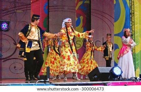 MOSCOW - JULY 18, 2015: Singer and dancers on stage. Sabantui celebration in Moscow, in Kolomenskoye park. Sabantui is a national Tatar and Bashkir festival, celebration of end of spring field work.