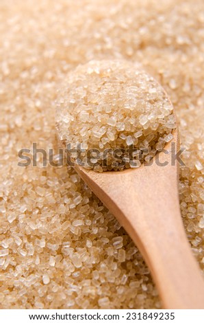 Healthier alternative brown sugar in a wood spoon.