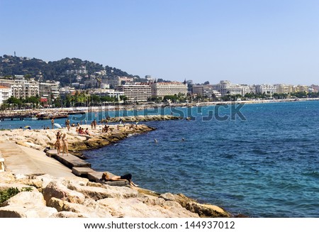 CANNES, FRANCE - August 17: Sunbathing people at Cannes Beach on August 17, 2009 in Cannes, south of France. Cannes beachfront, considered between 5 best urban beach of the Europe.