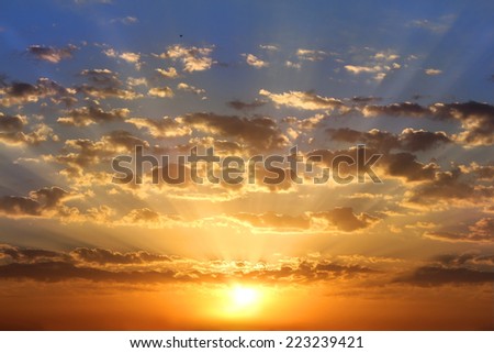 golden dawn, the sun\'s rays paint the sky and clouds in golden color