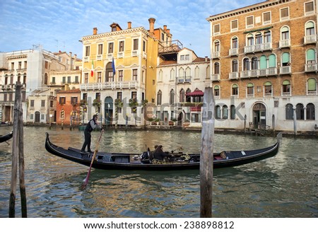 ITALY, VENICE - November 20: Gondolier on a gondola on the Grand Canal on November 20, 2014 in Venice. Gondola\'s are a major mode of touristic transport in Venice, Italy.