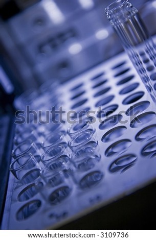 A rack of test tubes waiting to be analyzed. Shallow depth of field, with focus on the middle short tubes