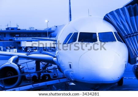 Close-up of aircraft ready for departure, early morning flight.  Blue monochrome