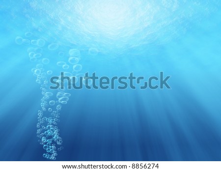 Looking up from under water, with sunrays streaming through water surface