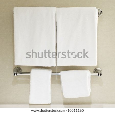 White towels hanging on towel rack