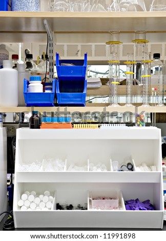 Typical chemistry lab bench, with many supplies and reagents on the shelves