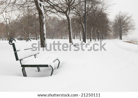 Snow covered bench on the Charles River Promenade