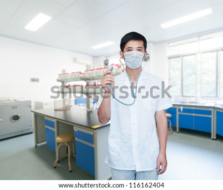 Asian male doctor with face mask portrait standing inside hospital building
