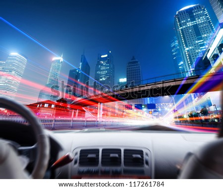 Driver\'s hands on a steering wheel of a car and night scene