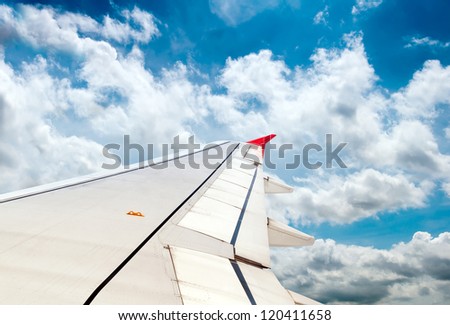 airplane wing, sky and clouds