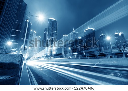 the light trails on the modern building background in shanghai china the light trails on the modern building background in shanghai china