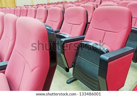 Empty hall for presentation with red armchairs