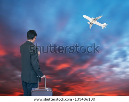 Busines person and plane on the background against cloudy sky