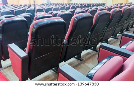Empty hall for presentation with red armchairs