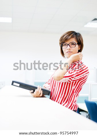 Educational / business people. Young Asian women holding a file in office environment.