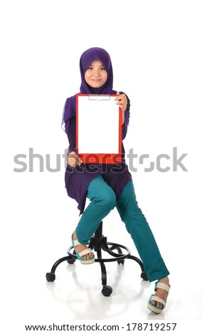 Young female holding writing pad