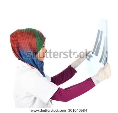 Young asian muslim successful doctor in head scarf looking at Xray results