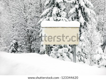 a empty sign in a winter setting where you can put in your own text