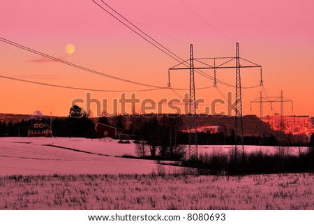 power lines in front of a winter sunset
